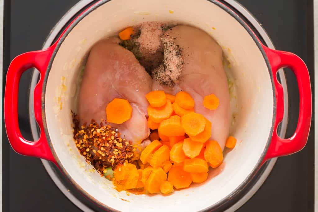 chicken breasts, vegetables cooking in soup pot