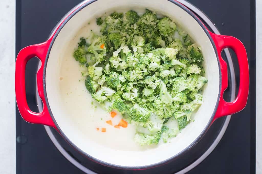 broccoli and diced carrots added to soup pot