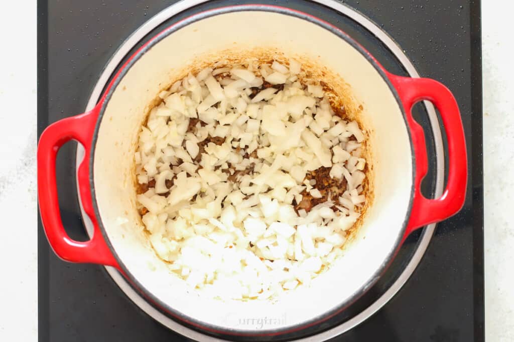 sauté diced onion and garlic in a pot.