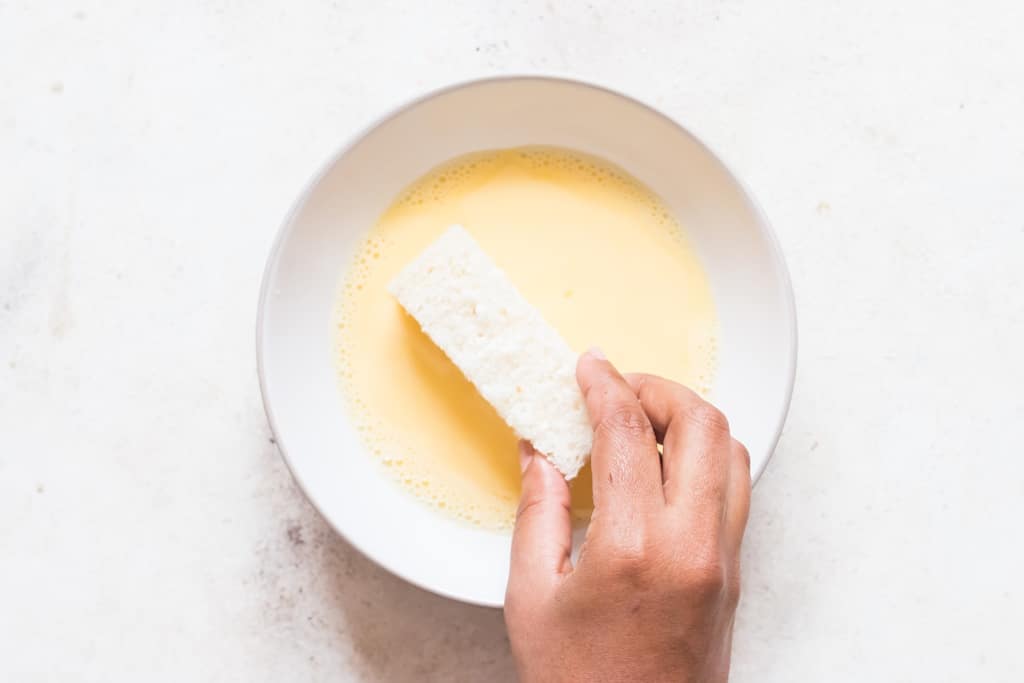 rolling bread sticks in egg mixture