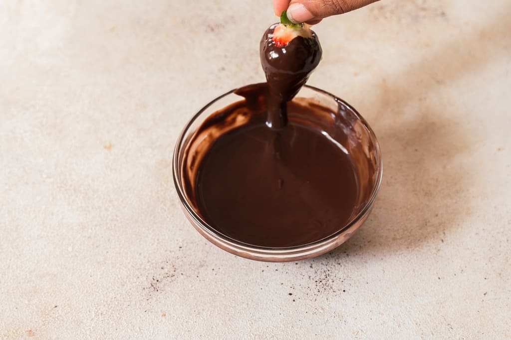 dipping strawberries in melted chocolate