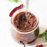 pesto made of sun dried tomatoes in glass jar with text