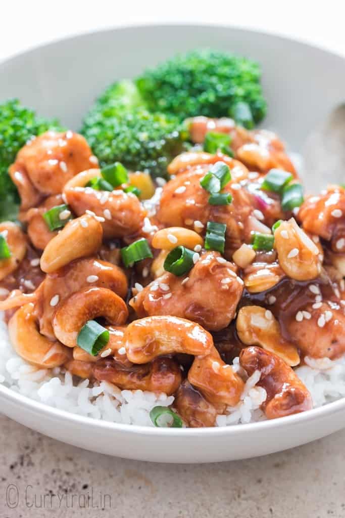 cashew chicken stir fry served over rice and broccoli in a bowl