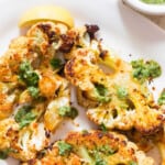 close view of roasted cauliflower steak with chimichurri sauce