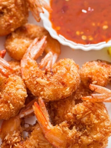 crispy coconut-crusted shrimp with red chili sauce for dipping.