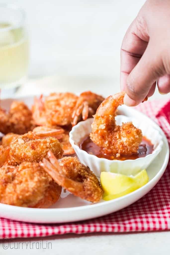 fried coconut shrimp dipped in sweet chili sauce.