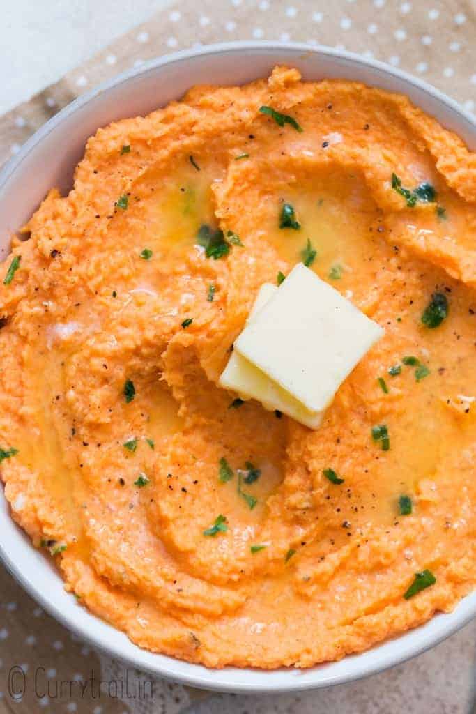 sweet potato mash served with cubes of butter in white bowl