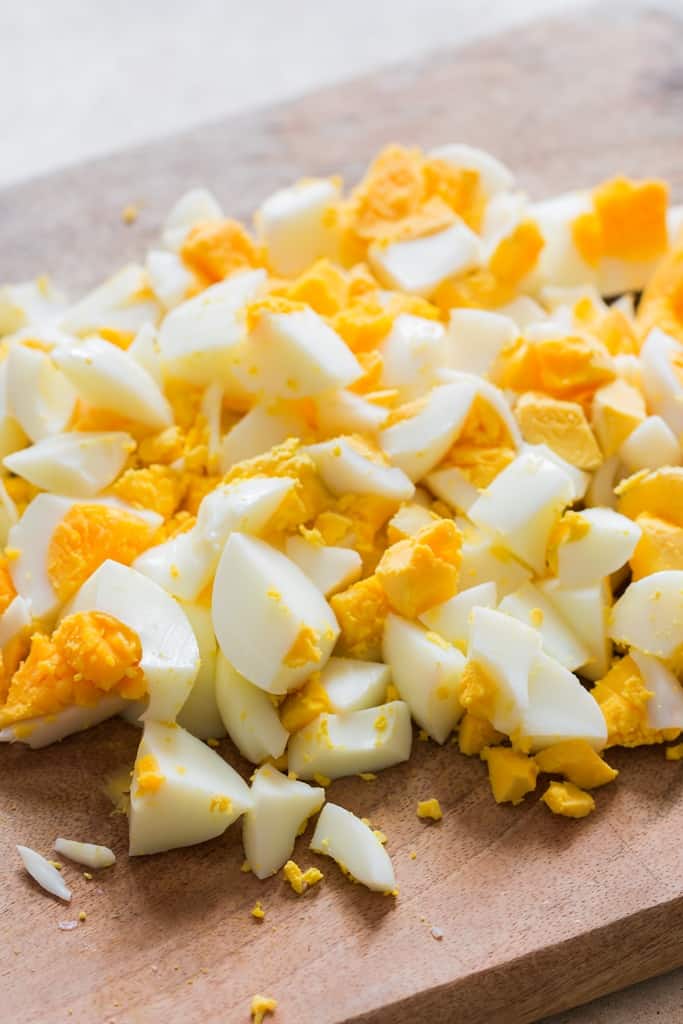 hard boiled eggs chopped up on board for egg salad recipe