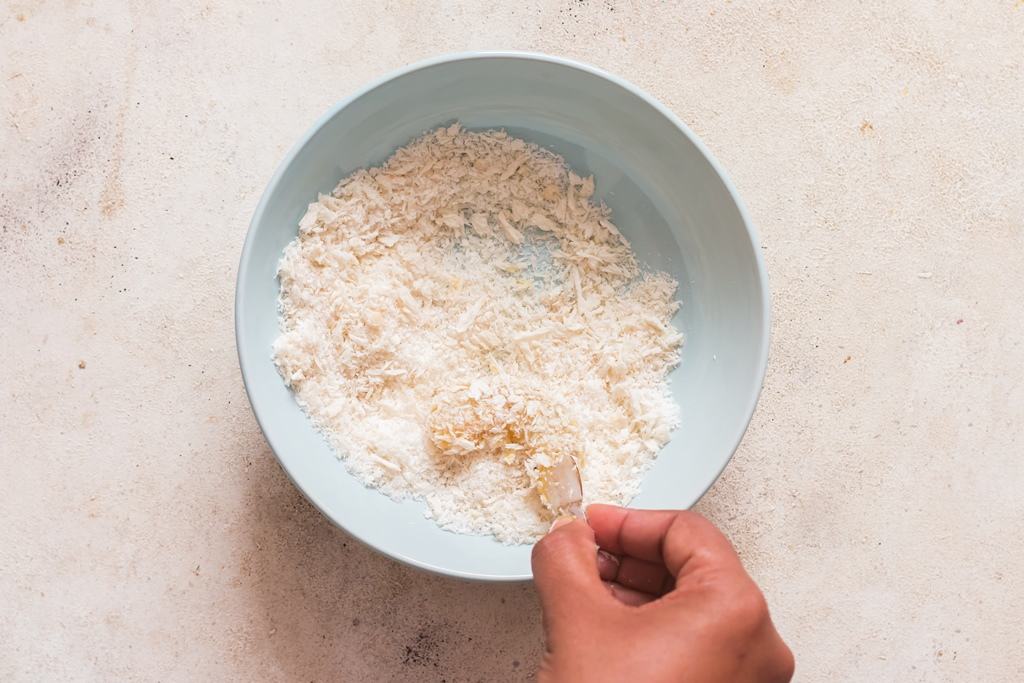 coating shrimps in shredded panko mix