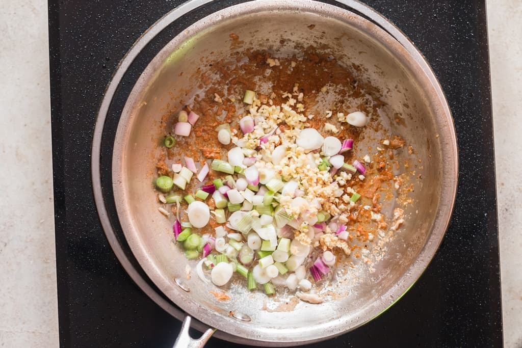 cooking white spring onion and ginger garlic in skillet