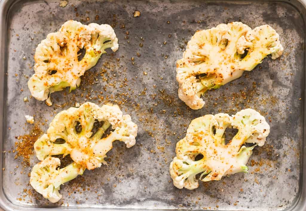 roasted cauliflower steaks on baking tray