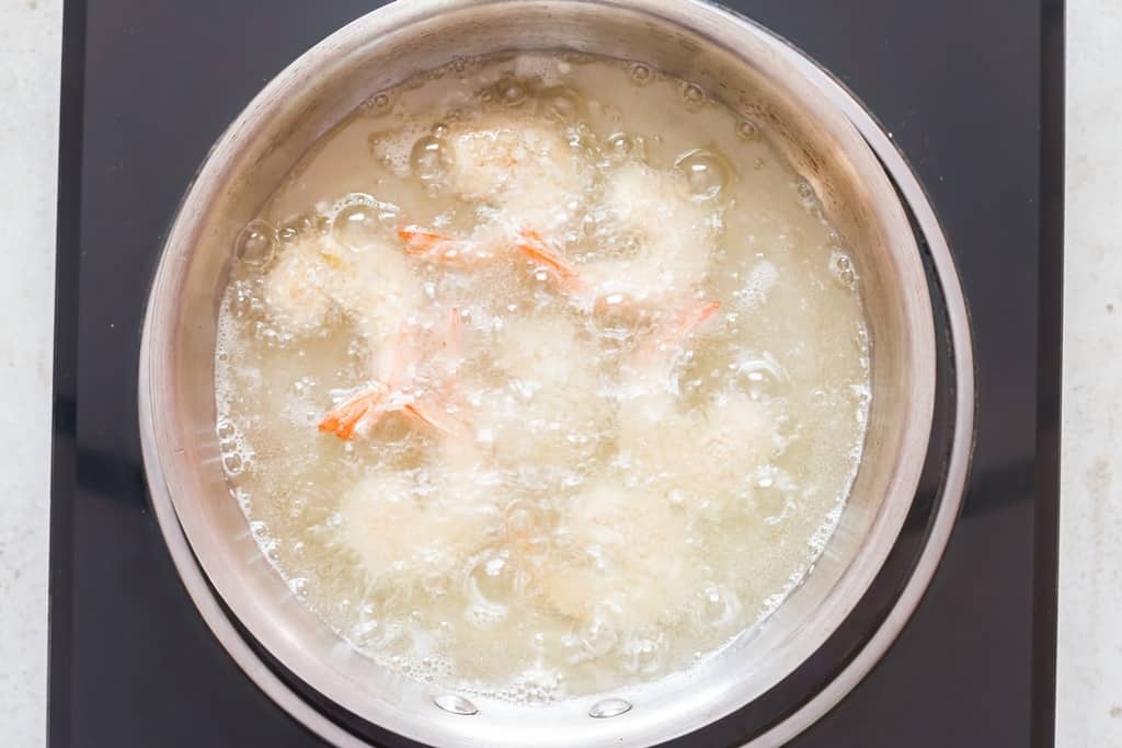 frying coconut-crusted shrimp in hot oil.