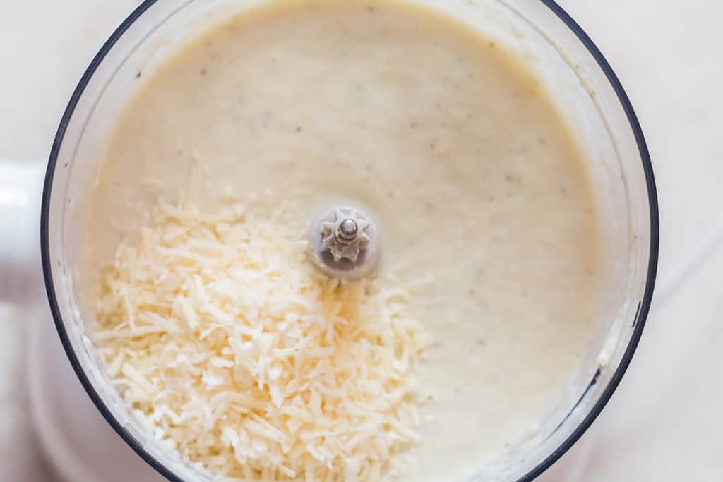 grated Parmesan cheese added to cauliflower cheese sauce