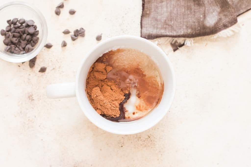 all ingredients of chocolate mug cake added to mug