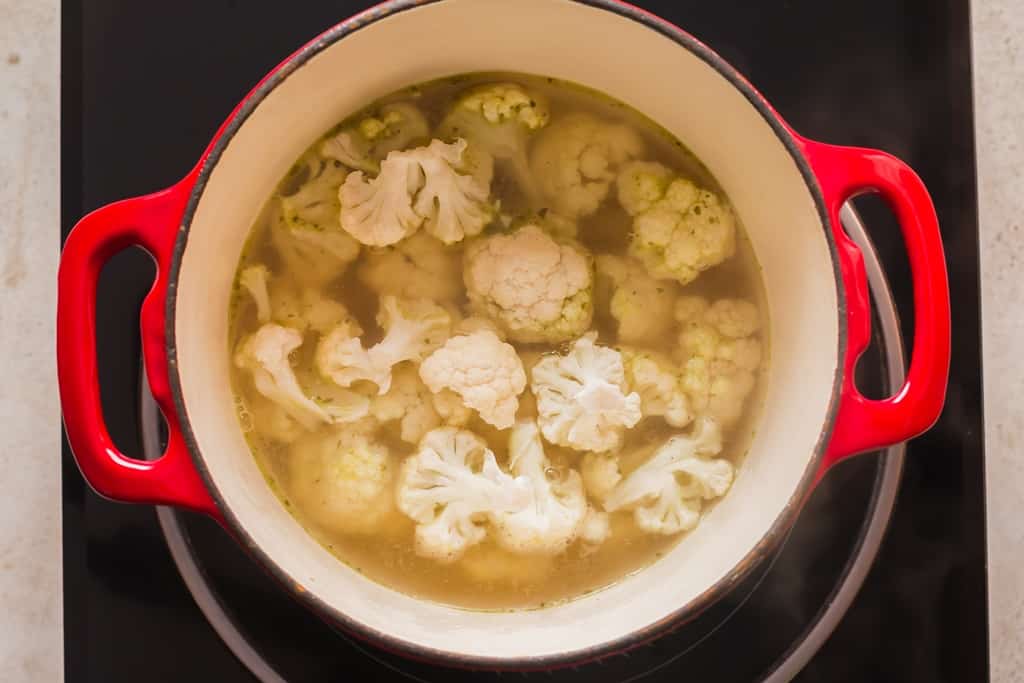 cooking cauliflower florest in vegetable broth in a stock pot