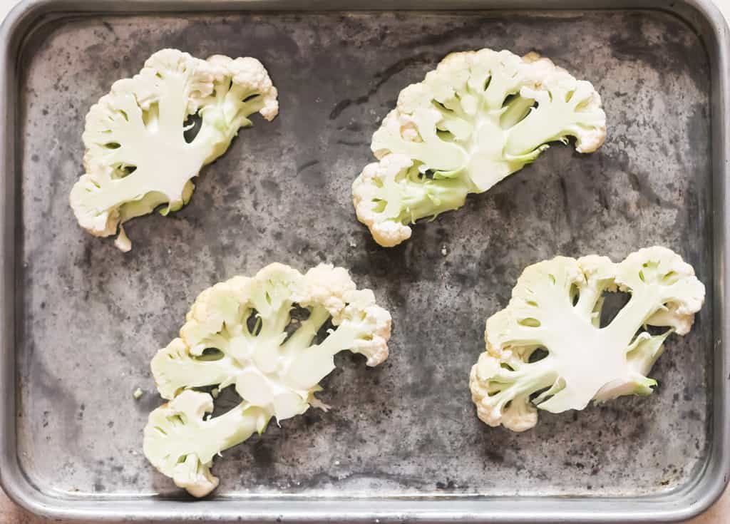 arrange cauliflower steaks on baking tray