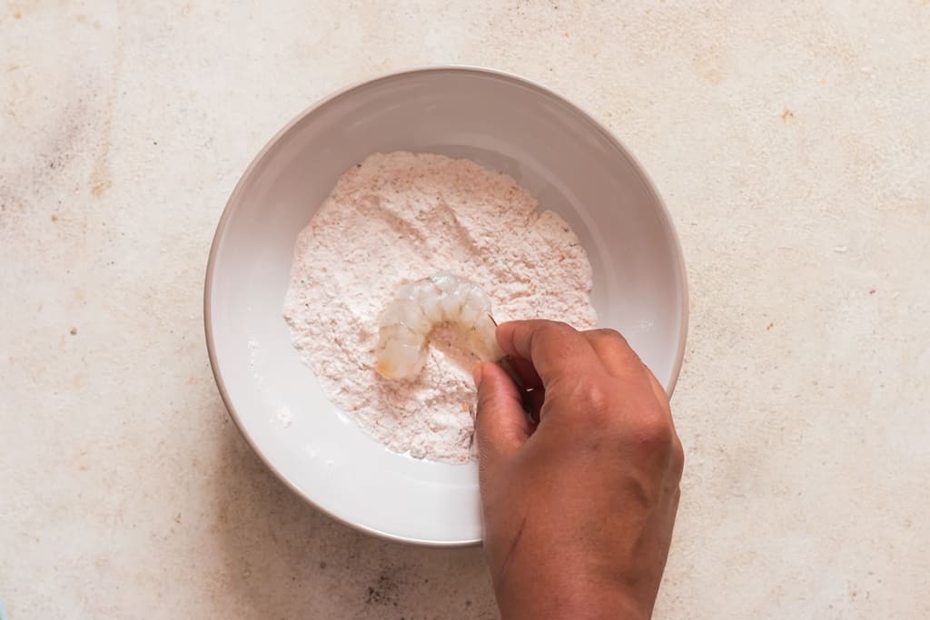 coating shrimps in the flour mix.