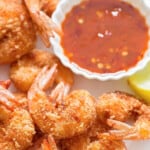 crispy coconut crusted shrimp with red chili sauce for dipping with text