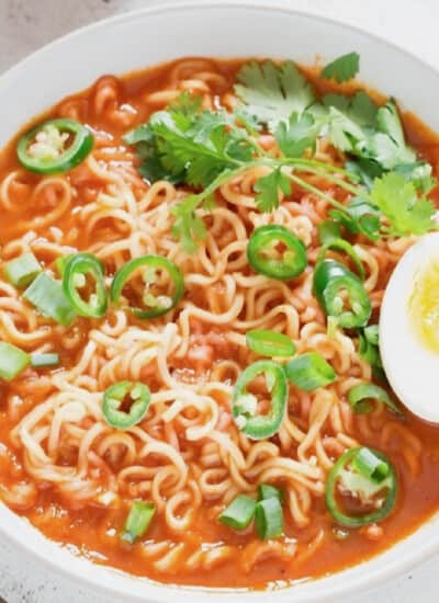 spicy sriracha ramen noodles soup topped with soft-boiled eggs.
