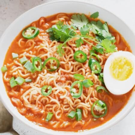 spicy sriracha ramen noodles soup topped with soft-boiled eggs.