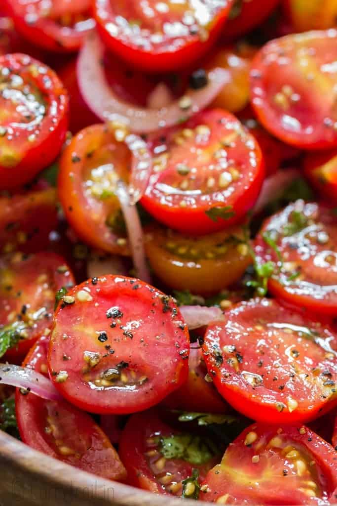 summer cherry tomato salad served in wooden salad bowl