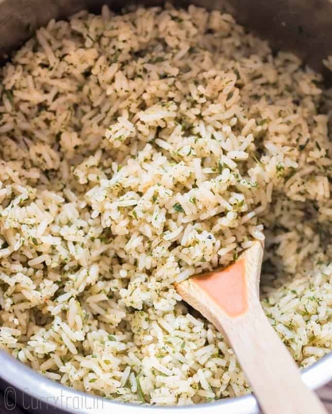 seasoned rice cooked in saucepan with spatula