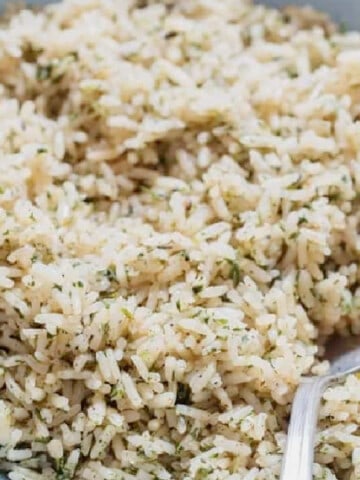 rice seasoned with herbs, and spices in a bowl.