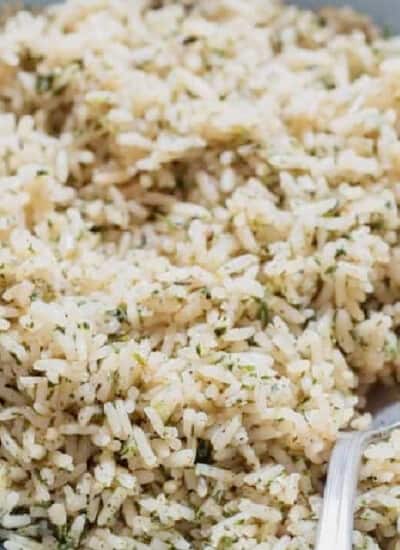 rice seasoned with herbs, and spices in a bowl.