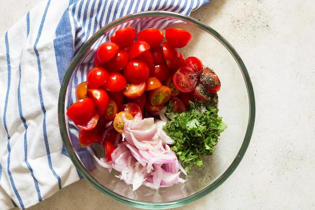 adding all ingredients into salad mixing bowl