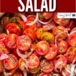 fresh tomato salad served in wooden salad bowl with text