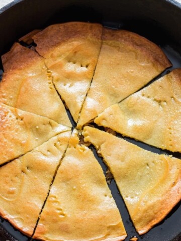 one ingredients socca flatbread cooked in cast iron skillet