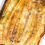 oven-roasted leeks with Parmesan cheese on a baking tray.