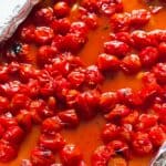 Roasted cherry tomatoes in baking tray.