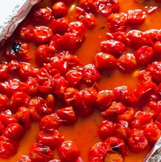 Roasted cherry tomatoes in baking tray.