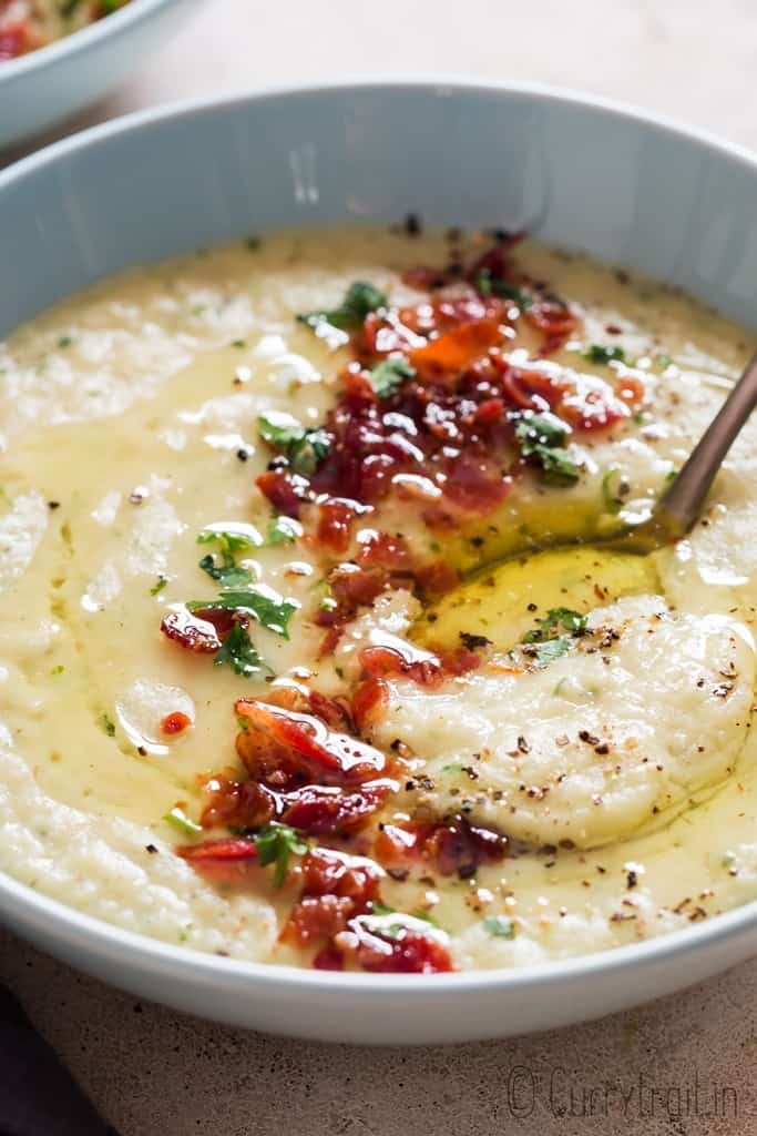 leek and potato soup served in ceramic soup bowl with bacon