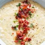 leek and potato soup served in ceramic soup bowl with bacon