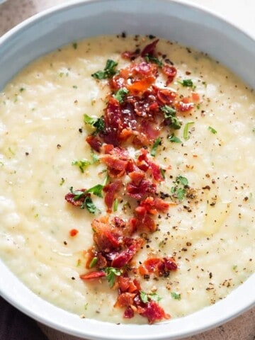 leek and potato soup served in ceramic soup bowl with bacon