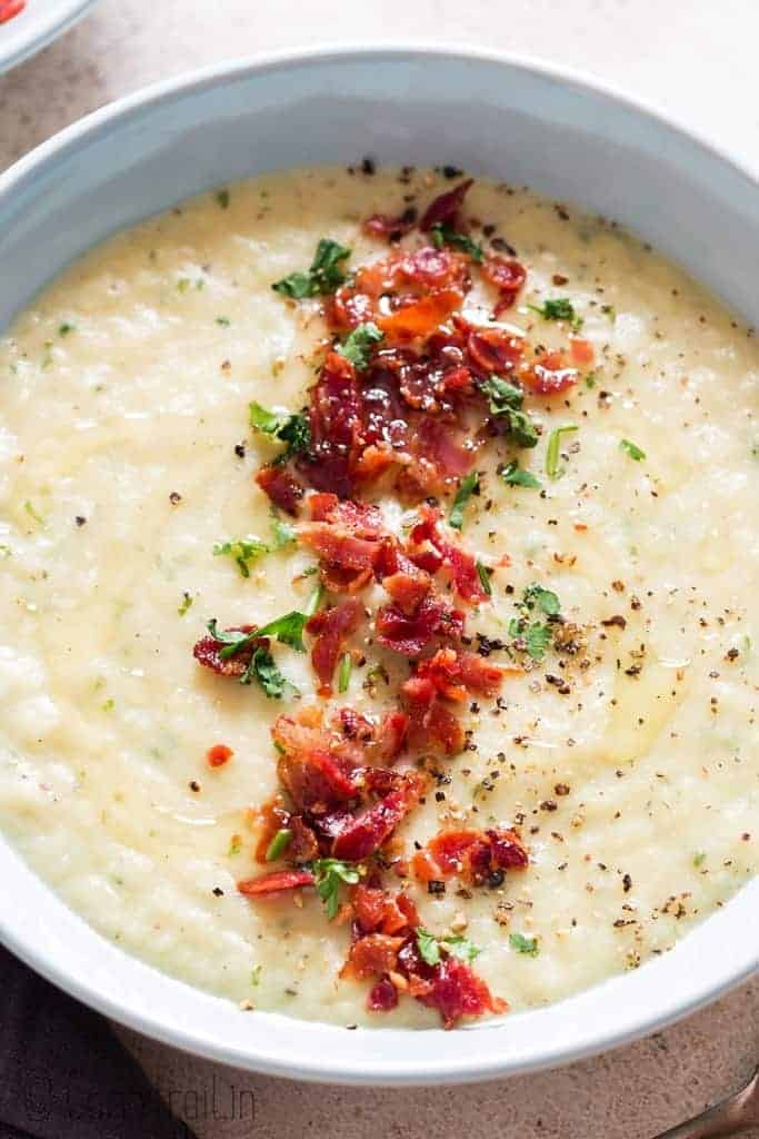 leek and potato soup served in ceramic soup bowl with bacon