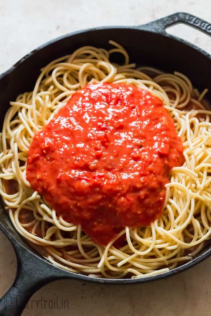 pasta with spicy tomato sauce in cast iron skillet.
