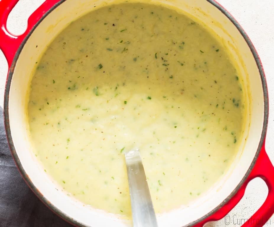 leek and potato soup in soup pot with ladle