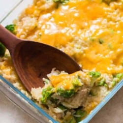 wooden spatula in cheesy broccoli rice casserole dish