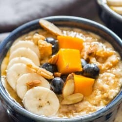 instant pot steel cut oats served with fruits and berries in ceramic bowls