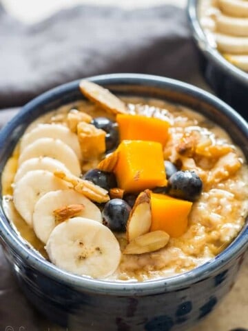 instant pot steel cut oats served with fruits and berries in ceramic bowls