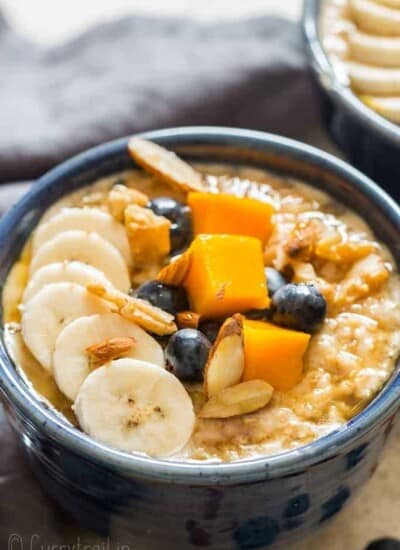 instant pot steel cut oats served with fruits and berries in ceramic bowls