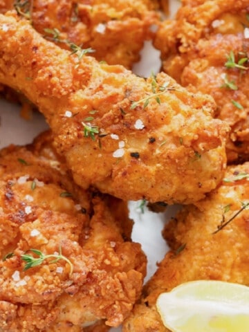 close up view of crispy fried chicken on a plate.