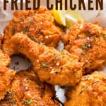 super crispy fried chicken made Southern style served with lemon wedges with text
