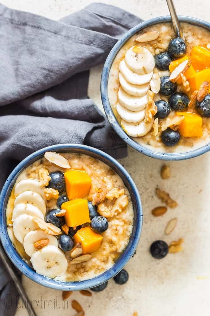 instant pot steel cut oats served with fruits and berries in ceramic bowls
