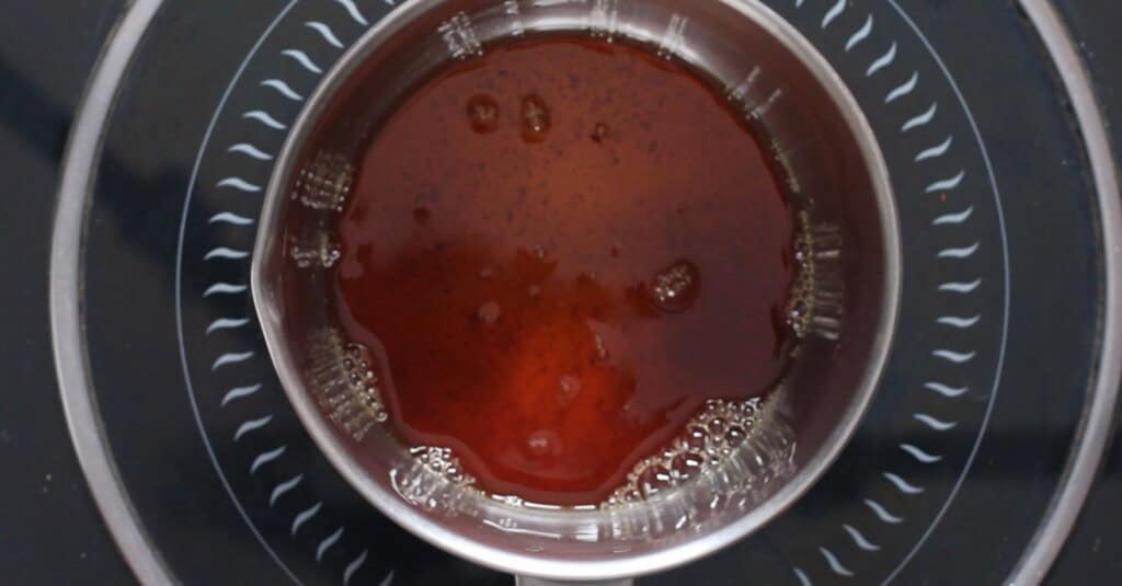 boiling brown sugar rum glaze in a saucepan.