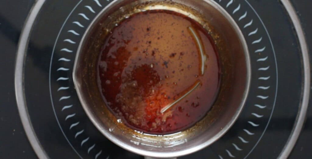 thick brown sugar rum glaze cooked in a sauce pan.