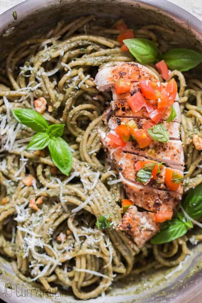 chicken pesto pasta with tomato salsa in skillet